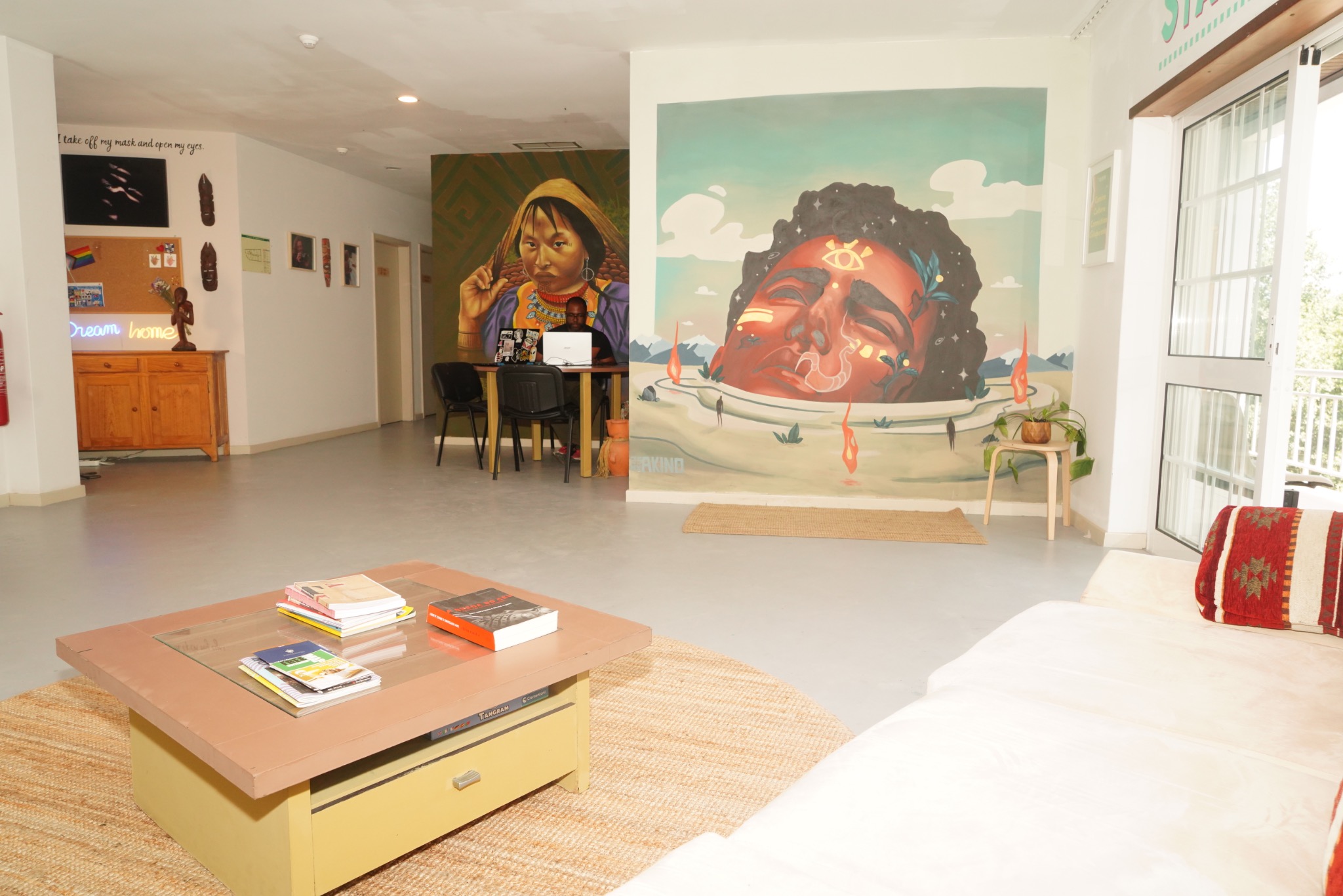 An art-filled shared room at StartArt Creative House